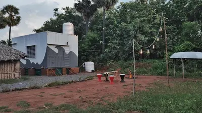 a building with a picnic table in front of it at Gypsy habitat Backpackers Space in Wodapatti