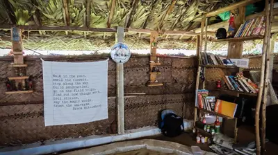 a room with a wall with a sign and books at Gypsy habitat Backpackers Space in Wodapatti