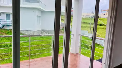 a view from the balcony of a house at Away From Home - 6 - Home Stay Ooty, Entire 3BHK Villa in Ooty