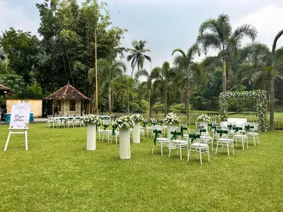 a bunch of tables and chairs in a field at Sparrow Vale Resort in Kotamangalam