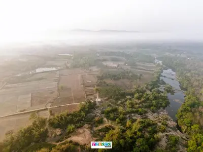 an aerial view of a river and a field at Rivana Homestay in Kushālnagar