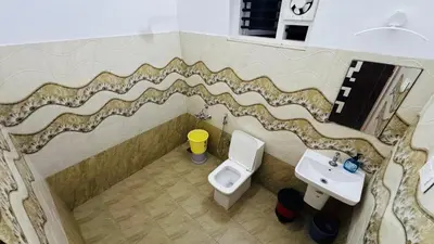 a bathroom with a toilet and a sink at mountain lake view private pool villa -Wayanad in Meppādi