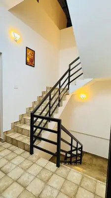 a staircase with a black railing in a building at mountain lake view private pool villa -Wayanad in Meppādi