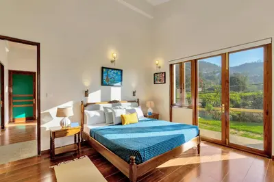 a bedroom with a bed and a large window at SaffronStays Coonoor Canvas in Coonoor