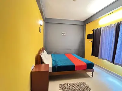 a bedroom with a bed with colorful walls at Munnar House in Munnar