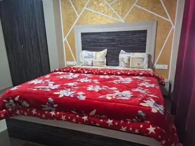 a bedroom with a bed with a red blanket and pillows at Golden Gate Luxury Villas by LexStays in Ooty