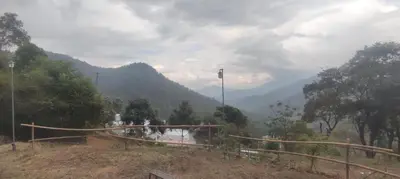 a view of a valley with a mountain in the background at Mount Camp in Marayoor