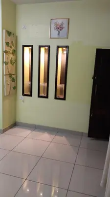a room with four mirrors on the wall with a tile floor at ZAREPHATH PG Home in Trichūr