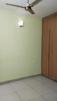 an empty room with a ceiling fan and a cabinet at ZAREPHATH PG Home in Trichūr