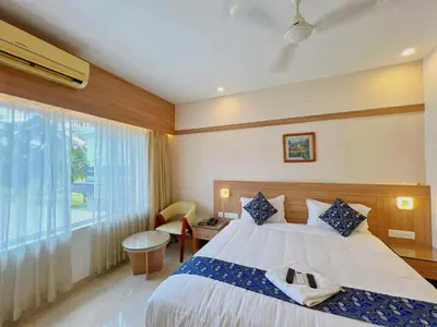 a bedroom with a large bed and a window at Hotel Amaravathi BY D2V in Manattala