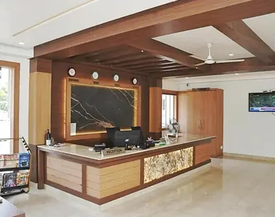a office with a counter with a blackboard on the wall at Hotel Amaravathi BY D2V in Manattala
