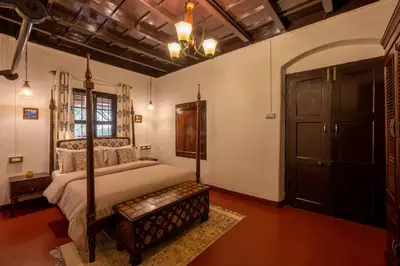 a bedroom with a bed and a large door at Sliceinn Escapes Pushpanjali - Madikeri, Coorg in Madikeri