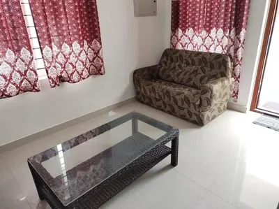 a living room with a couch and a glass table at Fully furnished 3BHK 2 Floor Villa in Angamali
