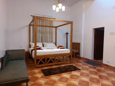 a bedroom with a canopy bed in a room at Jennings Abode Doddabetta in Ooty