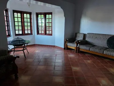 a living room with a couch and a table at Jennings Abode Doddabetta in Ooty