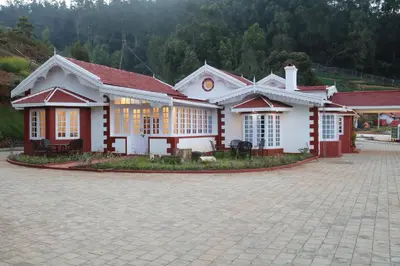 a white house with a red roof at Jennings Abode Doddabetta in Ooty
