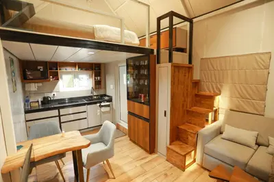 a room with a dining table and a loft bed at Shoreline Secrets in Trichūr