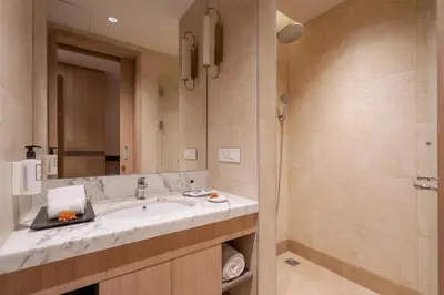 a bathroom with a sink and a shower at The Magnus in Coimbatore