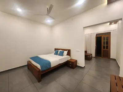 a bedroom with a bed and a ceiling fan at Mana Gramam Resort Mudumalai- Only For Indians,NRI in Mudumalai National Park