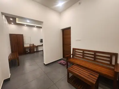 a empty room with a bench and a table at Mana Gramam Resort Mudumalai- Only For Indians,NRI in Mudumalai National Park