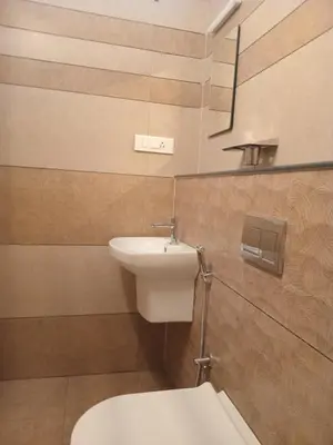 a bathroom with a white toilet and a sink at Dew Dreams Periyar Castle in Alwaye