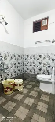 a bathroom with a toilet and a sink at The Bulbul Nest Homestay in Gūdalūr