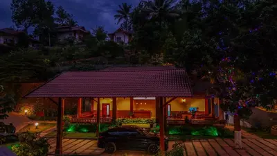 a house with a car parked in front of it at Silver Oak Resort Wayanad in Chithragiri