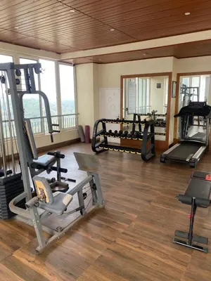 a gym with two treadmills and weights in a room at Peace of mind in Kakkayam