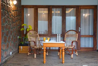 a table and two chairs on a patio at Mayaahi Resorts & Spa in Nilambūr