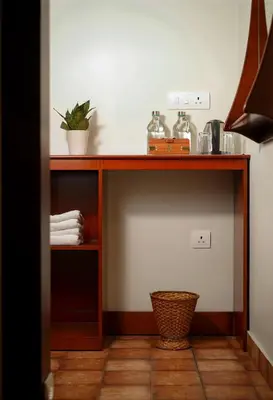 a wooden shelf with a plant on it in a room at Mayaahi Resorts & Spa in Nilambūr