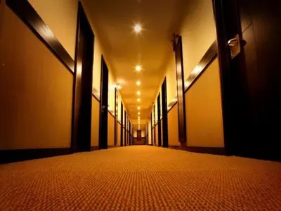 an empty hallway of a building with a long corridor at Sunflower Hotel in Mysore