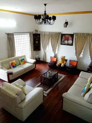 a living room with two couches and a table at Greendale in Kotagiri