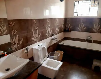 a bathroom with a toilet and a sink and a tub at Greendale in Kotagiri