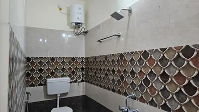 a bathroom with a toilet and a shower at Mahalakshmi Residency in Coimbatore