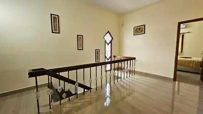 a hallway with a staircase and a room with a bed at Mahalakshmi Residency in Coimbatore