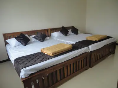 two twin beds sitting next to each other at Sanvika Hotels & Service Apartments in Coimbatore