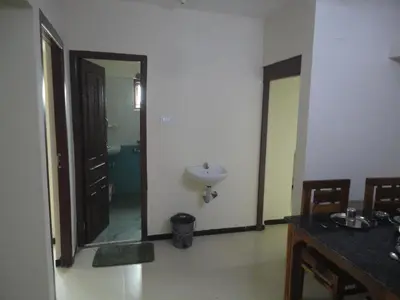a bathroom with a sink and a mirror at Sanvika Hotels & Service Apartments in Coimbatore