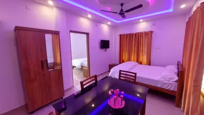 a bedroom with a bed and a table and a ceiling at Marayoor home stay in Marayoor