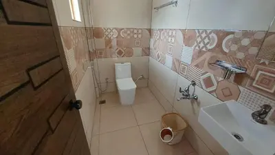 a bathroom with a toilet and a sink at Marayoor home stay in Marayoor