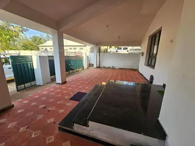an empty living room with a red brick floor at SHI's Shenba 3BHk Villa Near Ganga Hospital Coimbatore in Coimbatore