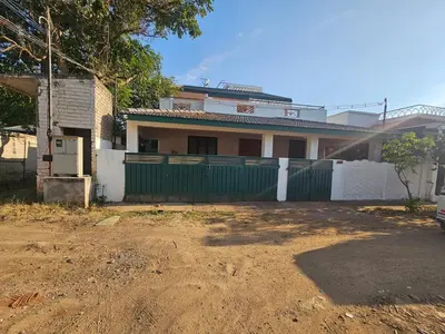 a green fence in front of a house at SHI's Shenba 3BHk Villa Near Ganga Hospital Coimbatore in Coimbatore