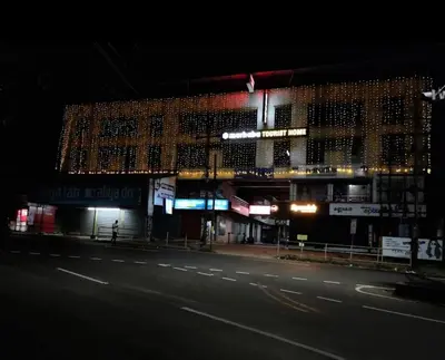 a building on a city street at night at Marhaba tourist home in Kunnamangalam