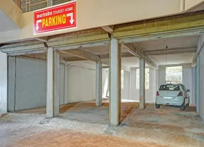 a parking garage with a car parked in it at Marhaba tourist home in Kunnamangalam