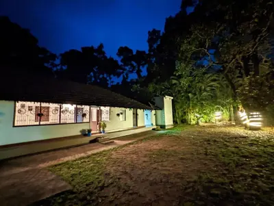 a house at night with the lights on at Wintervilla Cottages in Meppādi
