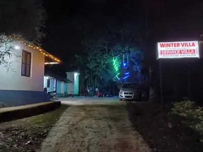 a car parked on a dirt road at night at Wintervilla Cottages in Meppādi