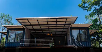 a house with awning on top of it at Trumpet Deck in Kutta