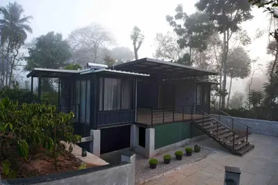 a small house in the middle of a garden at Trumpet Deck in Kutta
