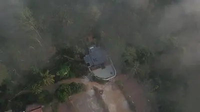 an aerial view of a house in a forest at Trumpet Deck in Kutta