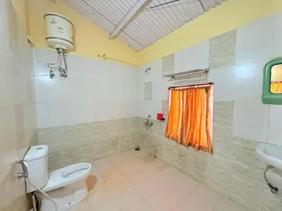 a bathroom with a toilet and a sink at Ubuntu Retreat - Aaram & Mukaam in Ooty