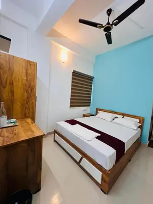a bedroom with a bed and a ceiling fan at SN RESiDENCY in Kozhikode